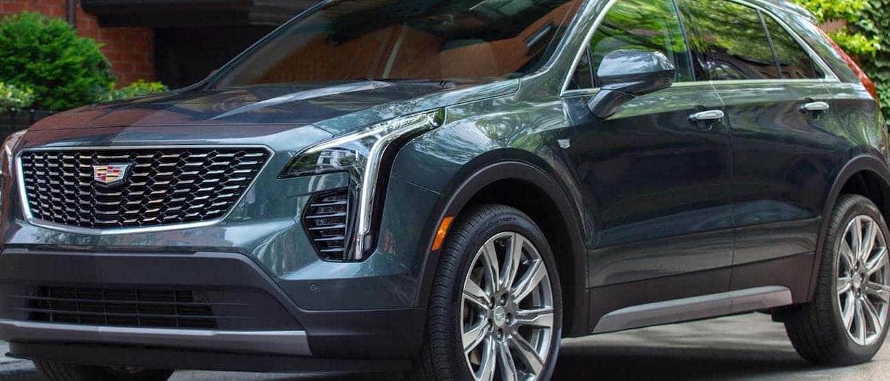 A gray 2020 Cadillac XT4 is parked in front of a Fort Worth, TX, building.