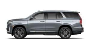 A blue/silver 2021 Cadillac Escalade is facing left against a white background.