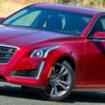 A used red 2015 Cadillac CTS VSport is parked on a road outside Fort Worth, TX.