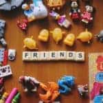 A Collection of Children's Toys and the Word 'Friends' Spelled Out with Scrabble Pieces