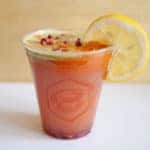 cold pressed juice drink with lemon garnish