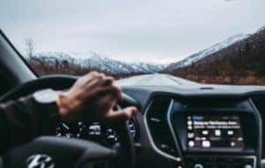 person driving with mountain scenery