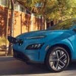 Blue 2022 Hyundai Kona Plugged in to a charging port