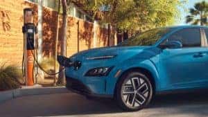 Blue 2022 Hyundai Kona Plugged in to a charging port