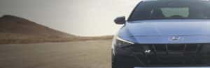 Hyundai N Line Performance Vehicle driving on the road with a sunset
