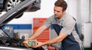 Hyundai Oil changes being done in fort worth, tx. Hyundai service technician putting oil in a hyundai car