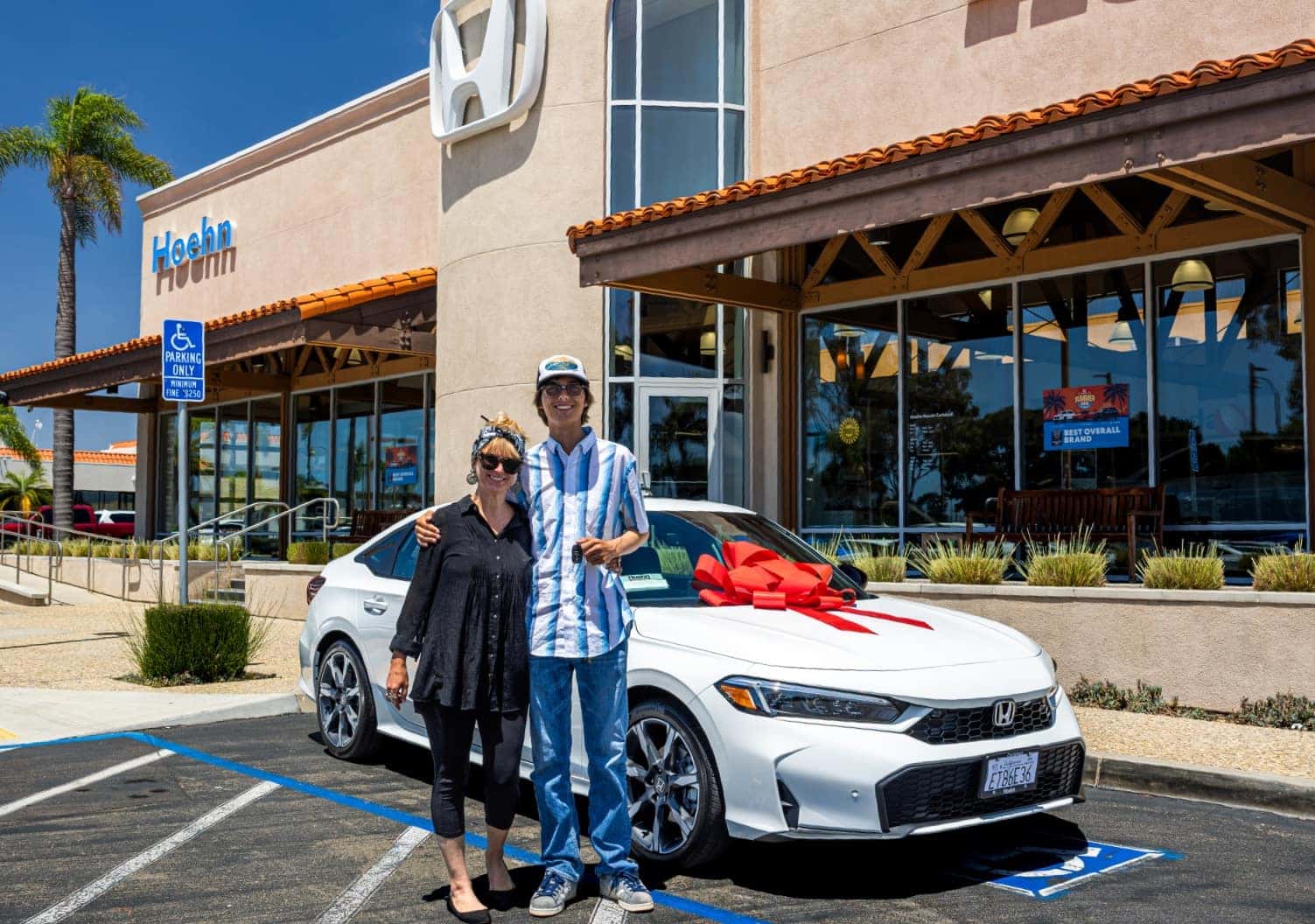 Happy customers with their new Honda outside Hoehn Honda Carlsbad