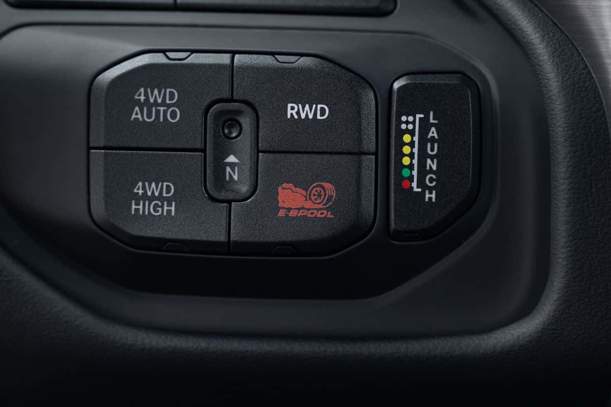 Center console controls showing the RWD-disconnect button and active suspension toggles in the 2027 Ram 1500 Rumble Bee