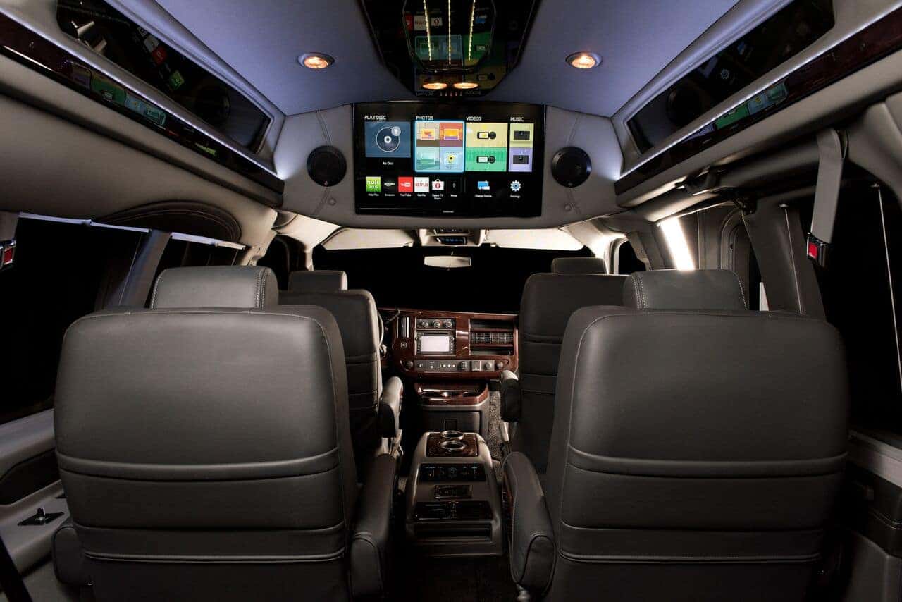 Interior of Chevrolet Conversion Van seating and HDTV