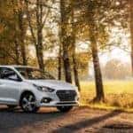 a hyundai car parked in a field at sunset