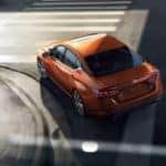 orange nissan altima turning on road