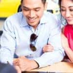 couple looking at paperwork and smiling