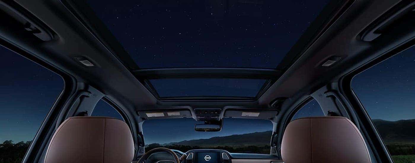 The panoramic moonroof is shown from a low angle inside a 2021 Nissan Titan, available at your local Nissan truck dealer.