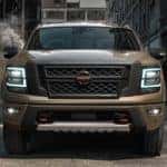A brown 2021 Nissan Titan is parked in an alleyway after leaving a Nissan truck dealer.