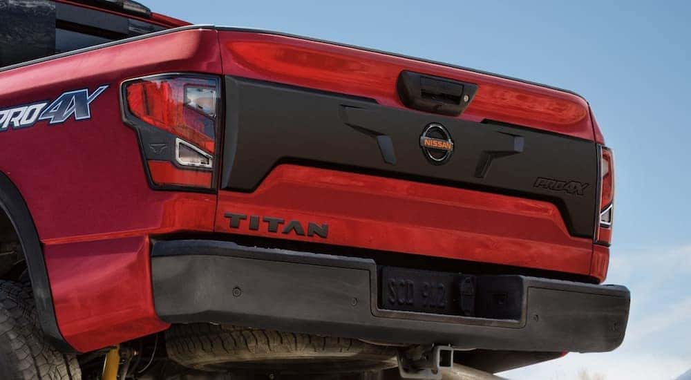 A close up shows the lift-gate of a red 2021 Nissan Titan.