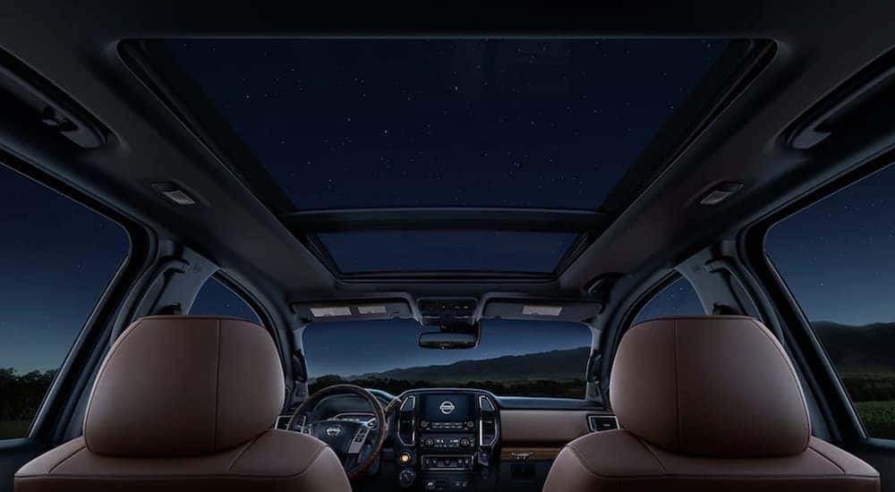 The interior of a 2021 Nissan Titan shows the moon roof and two front seats.