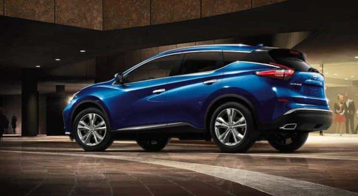 A blue 2021 Nissan Murano is shown parked in a modern lobby.