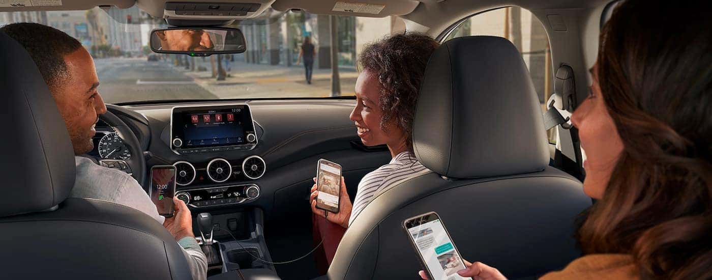 People are shown with phones having a conversation in a 2021 Nissan Sentra.