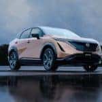 A copper 2022 Nissan Ariya is shown from a low angle.