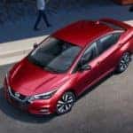 A red 2022 Nissan Versa is shown from a high angle while parking after leaving a Tullahoma Nissan dealer.