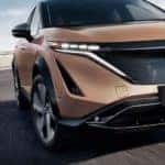 A gold 2023 Nissan ARIYA is shown after leaving a Nissan SUV dealer.