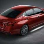 Aerial view of a red 2023 Nissan Altima SL on a showroom floor.