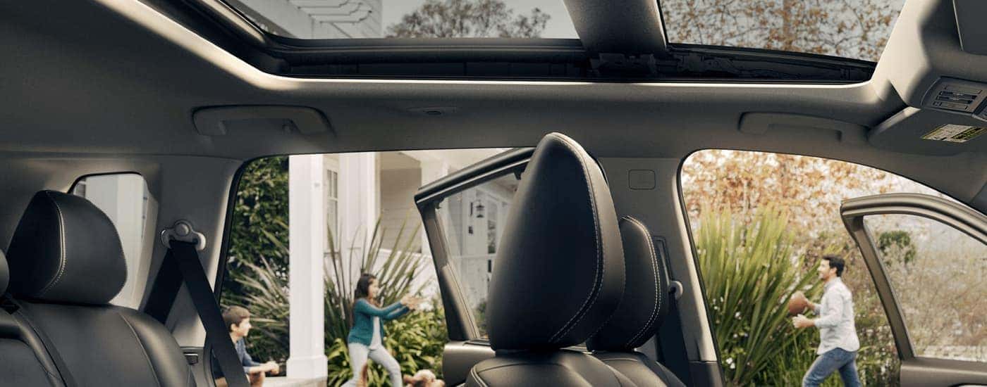 The headrests and sunroof in a 2023 Nissan Rogue is shown from the side.