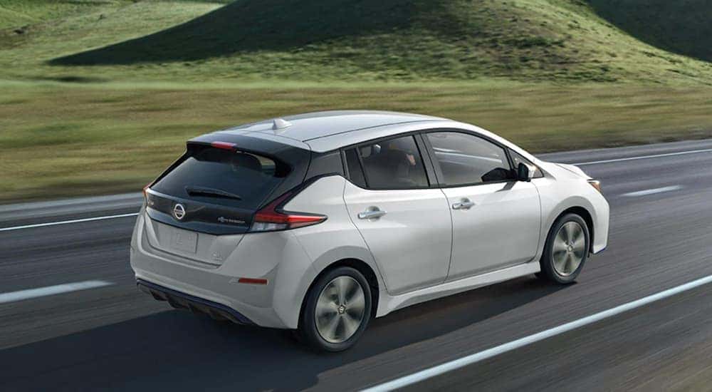 A white 2023 Nissan LEAF is shown from the rear at an angle.