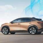 A bronze 2023 Nissan Ariya is shown from the size on the highway after leaving a Nissan dealer near Columbia, TN.