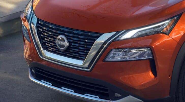 The grille on an orange 2023 Nissan Rogue near Columbia, TN is shown.