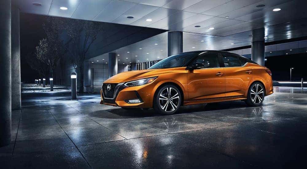 An orange 2023 Nissan Sentra is shown from the side after leaving a dealer that has a Nissan Sentra for sale in Shelbyville.
