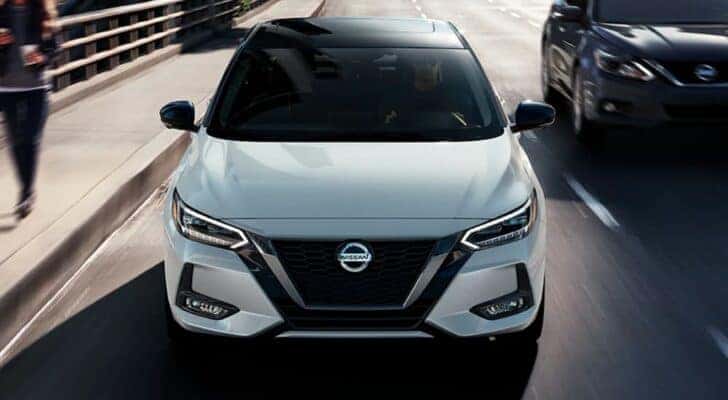 A white 2021 Nissan Sentra is shown from the front after leaving a dealer that has a Nissan Sentra for sale in Shelbyville.