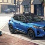 A blue 2023 Nissan Kicks SR is shown parked near a café after visiting a Nissan Kicks for sale.