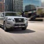 A grey 2024 Nissan Armada is shown from the front at an angle on a city street after leaving a dealer that has a Nissan Armada for sale.