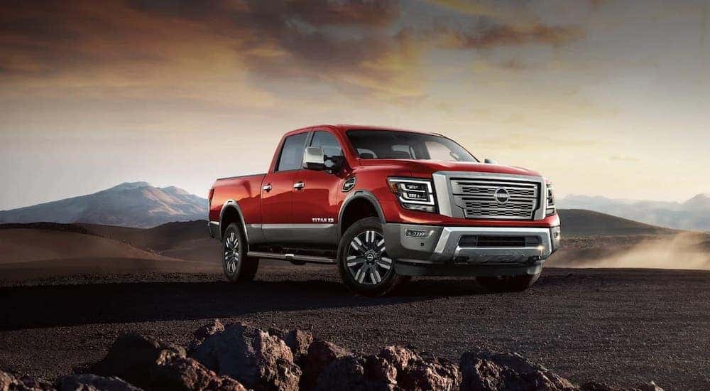 A red 2024 Nissan Titan XL is shown parked.
