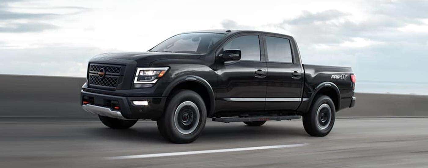 A black 2021 Nissan Titan Pro-4x is shown form the side.