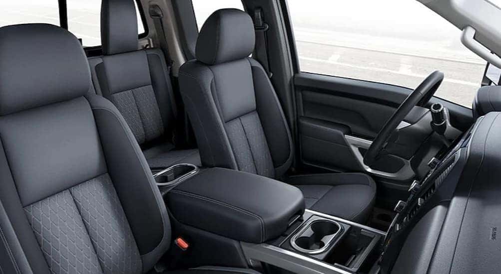 The gray interior and dash of a 2024 Nissan Titan is shown.