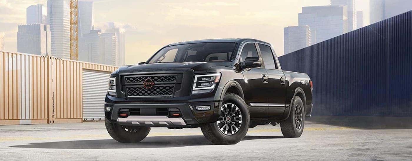 A black 2024 Nissan Titan is shown from the front at an angle after leaving a dealer that has a Nissan Titan for sale near Lewisburg (TN).