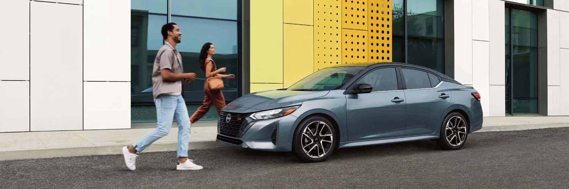 couple walking to 2025 nissan sentra