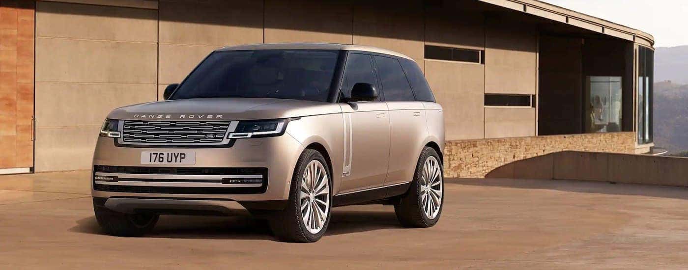 A tan 2025 Range Rover is shown from the front at an angle.