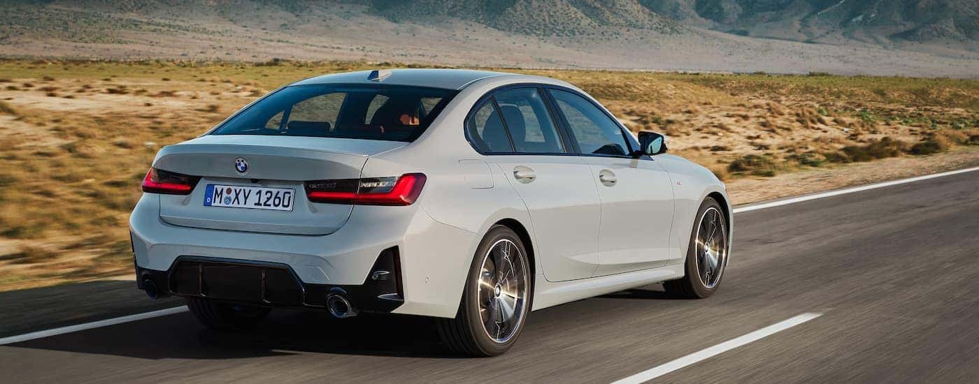 A grey 2022 BMW 3 Series is shown from the rear at an angle.