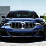 Head-on view of a blue 2022 BMW 5 Series, a used BMW for sale.