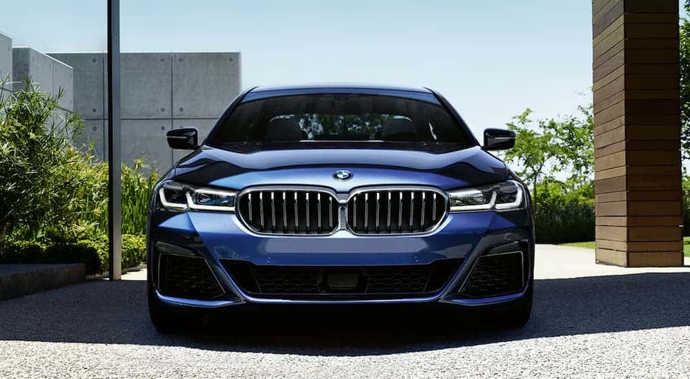 Head-on view of a blue 2022 BMW 5 Series, a used BMW for sale.