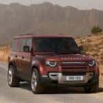 A red 2025 Land Rover Defender for sale is shown from the front at an angle.