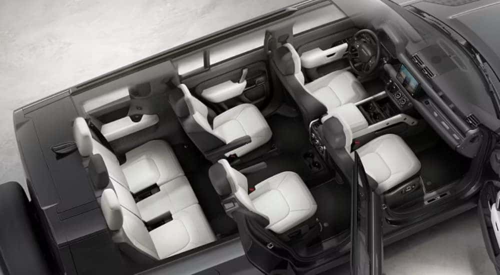 The white interior of a 2025 Land Rover Defender 130 is shown from a high angle cutaway.