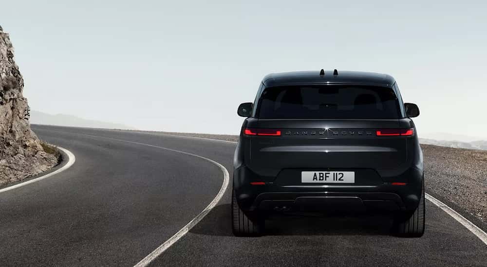 Black 2025 Range Rover Sport driving around a bend.