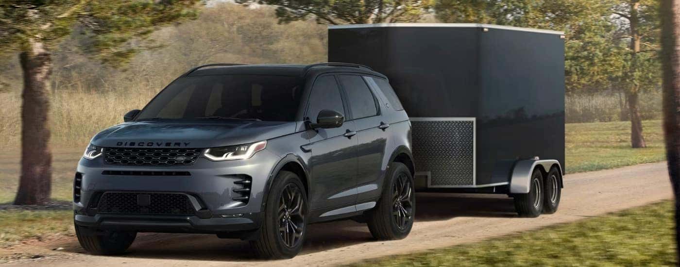 A grey 2025 Land Rover Discovery Sport from the front at an angle after leaving a Land Rover dealer near Omaha.