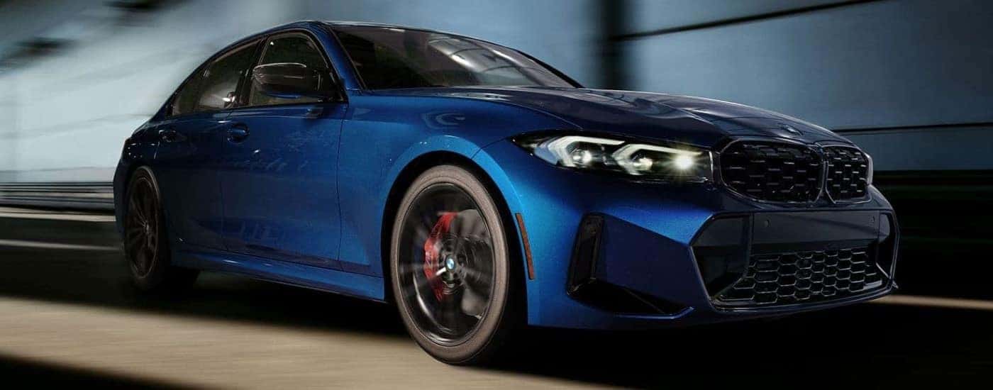 A blue 2024 BMW 3 Series driving in a tunnel