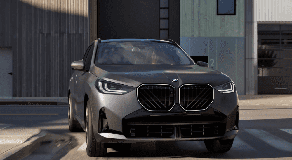 Silver 2025 BMW X3 turning a corner