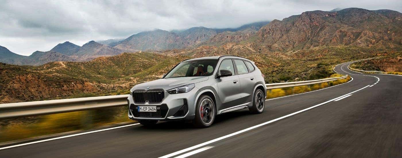 A silver 2025 BMW X1 from the front at an angle.